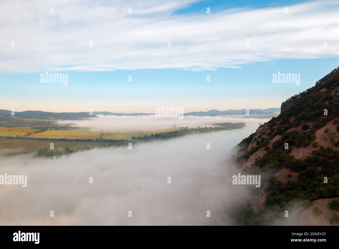 Foggy morning over the Danube river in Hugary. This photo made in Danube bend near by Esztergom city. Amazing landscape with haze. Stock Photo