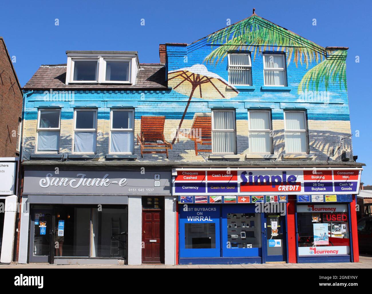 Colourful Beach Art by Paul Curtis Above Sunjunk-E Beauty & Tanning Parlour As Part of A Regeneration Project in New Ferry, Merseyside, UK Stock Photo