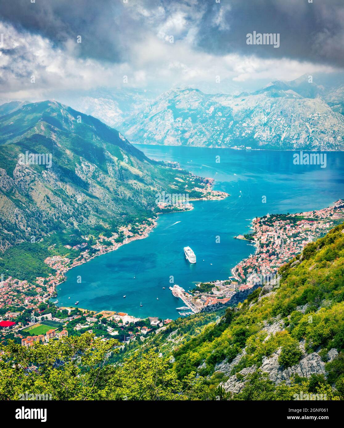Fantastic summer cityscape of Kotor port. Aerial morning view of Kotor bay and  limestone cliffs of Mt. Lovcen. Sunny Adriatic seascape. Beautiful wor Stock Photo
