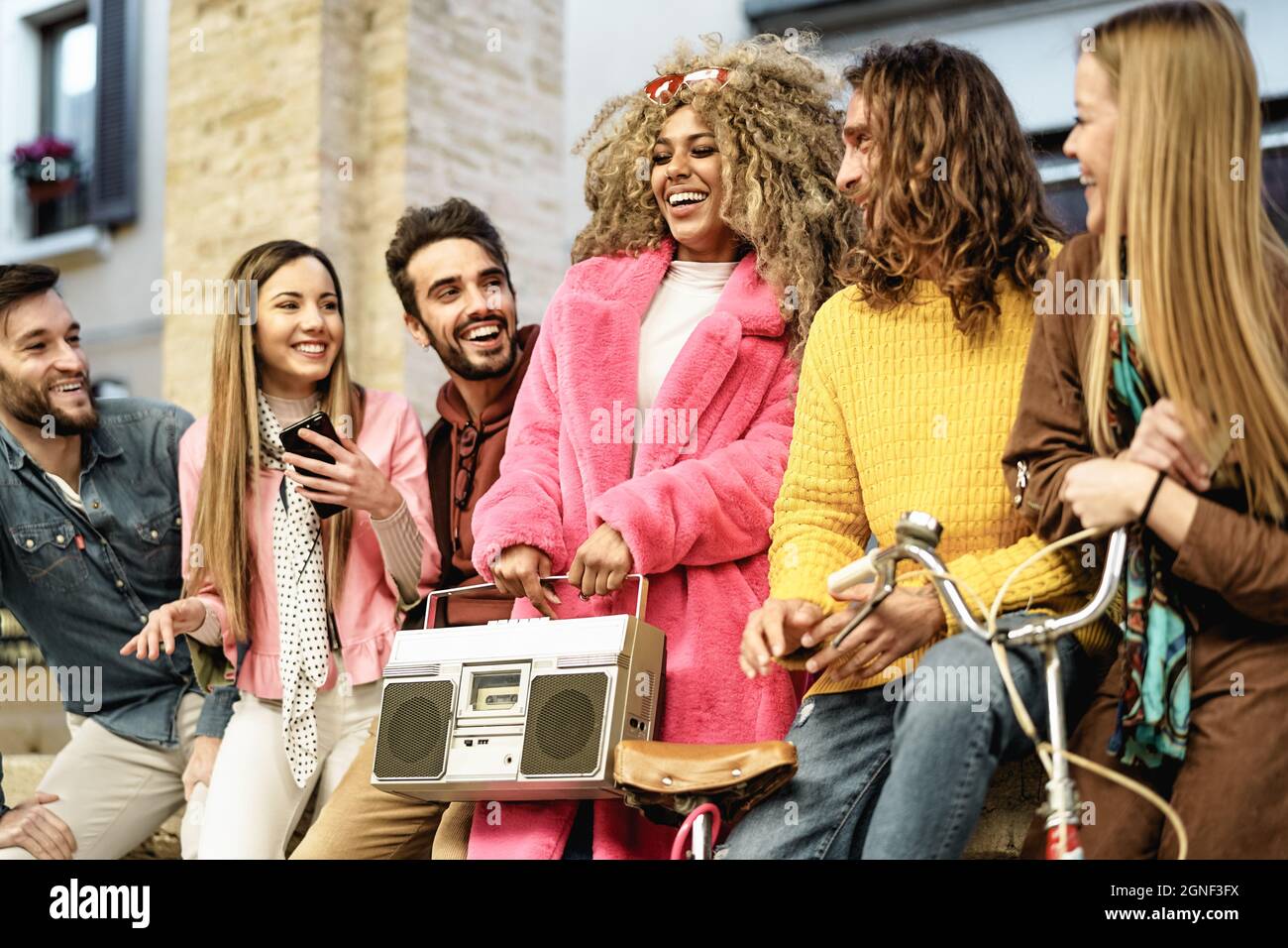Young multiracial friends having fun listening music with vintage boombox stereo - Youth millennial lifestyle concept Stock Photo