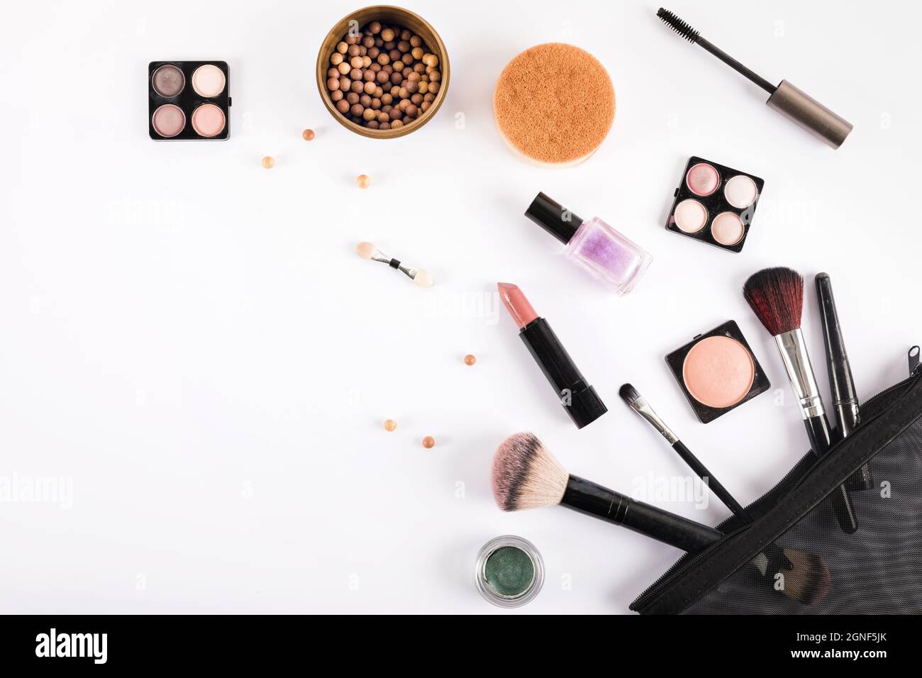 elevated view makeup brushes cosmetics white backdrop. High quality and 