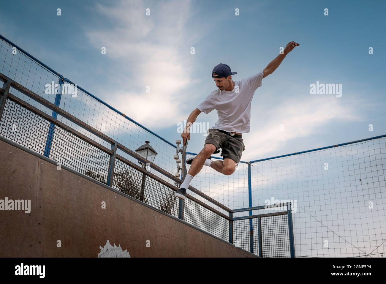 young man skateboarding on the ramp of a skate park Stock Photo - Alamy