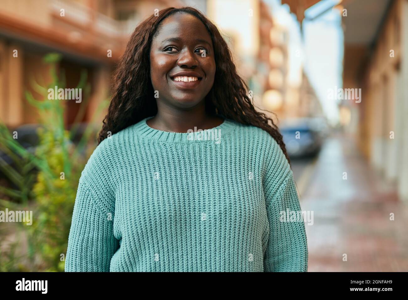Young african woman smiling happy at the city Stock Photo - Alamy