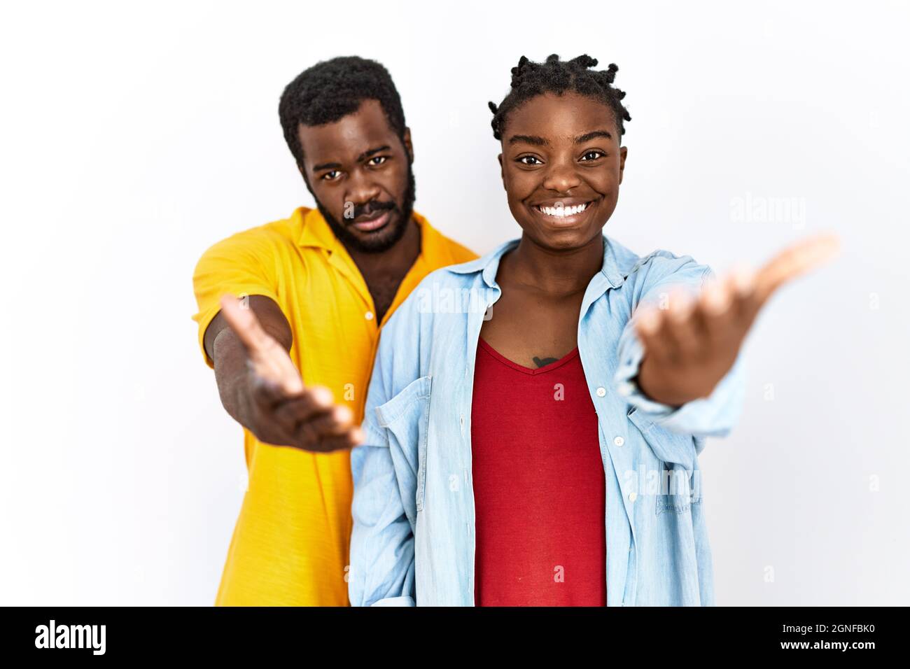 Young african american couple wearing casual clothes smiling friendly ...