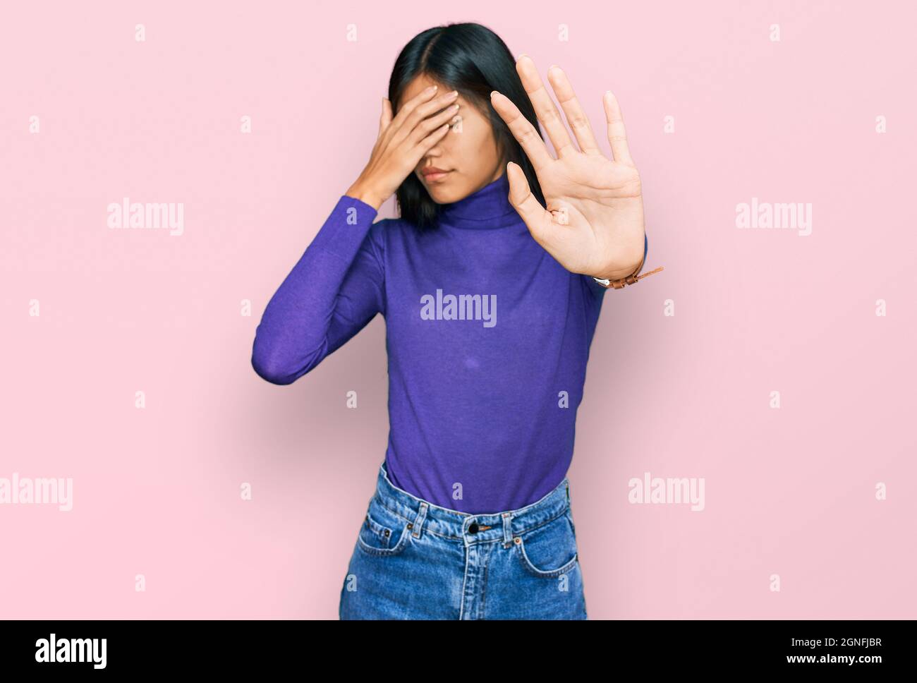 Beautiful young asian woman wearing casual clothes covering eyes with hands and doing stop gesture with sad and fear expression. embarrassed and negat Stock Photo