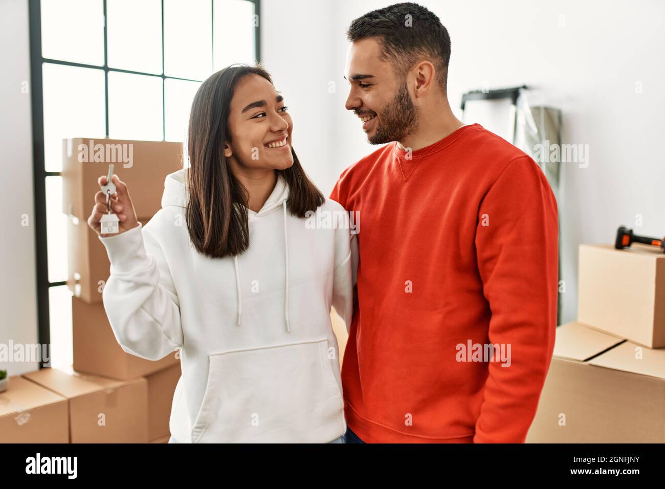 Young hispanic couple smiling happy holding key of new home Stock Photo ...
