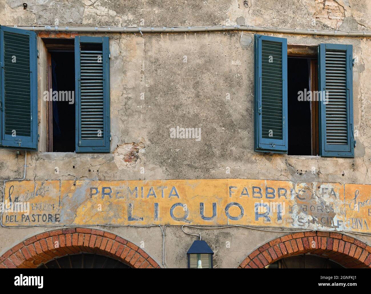 The faded sign of the historic liquor distillery 'Emilio Borsi', founded in 1800 in the old town of Castagneto Carducci, Livorno, Tuscany Stock Photo