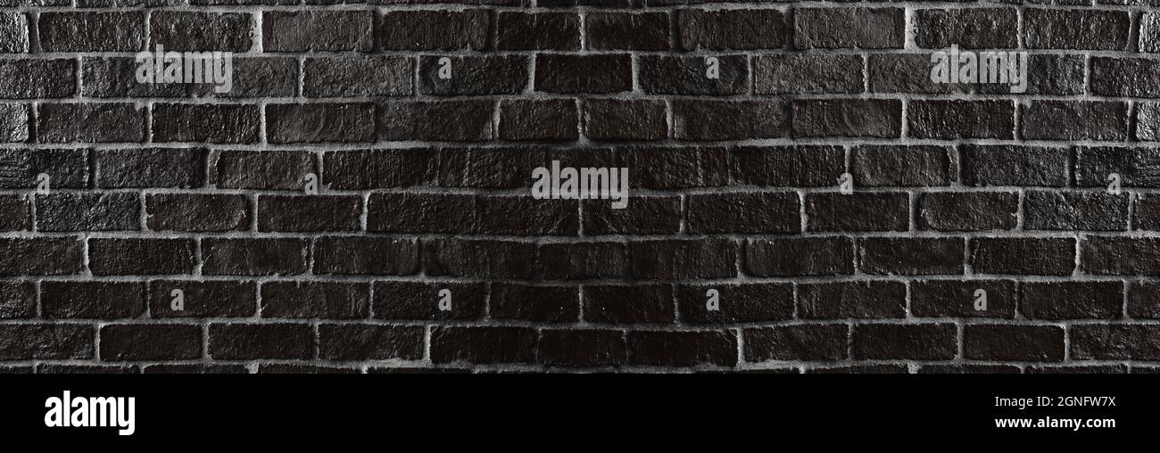 Texture black brick wall of dark color for the background design. Stock Photo