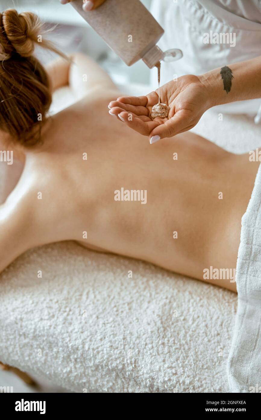 confident female specialist is doing relaxing body massage for beautyful  slim caucasian lady at minimalistic spa salon Stock Photo - Alamy