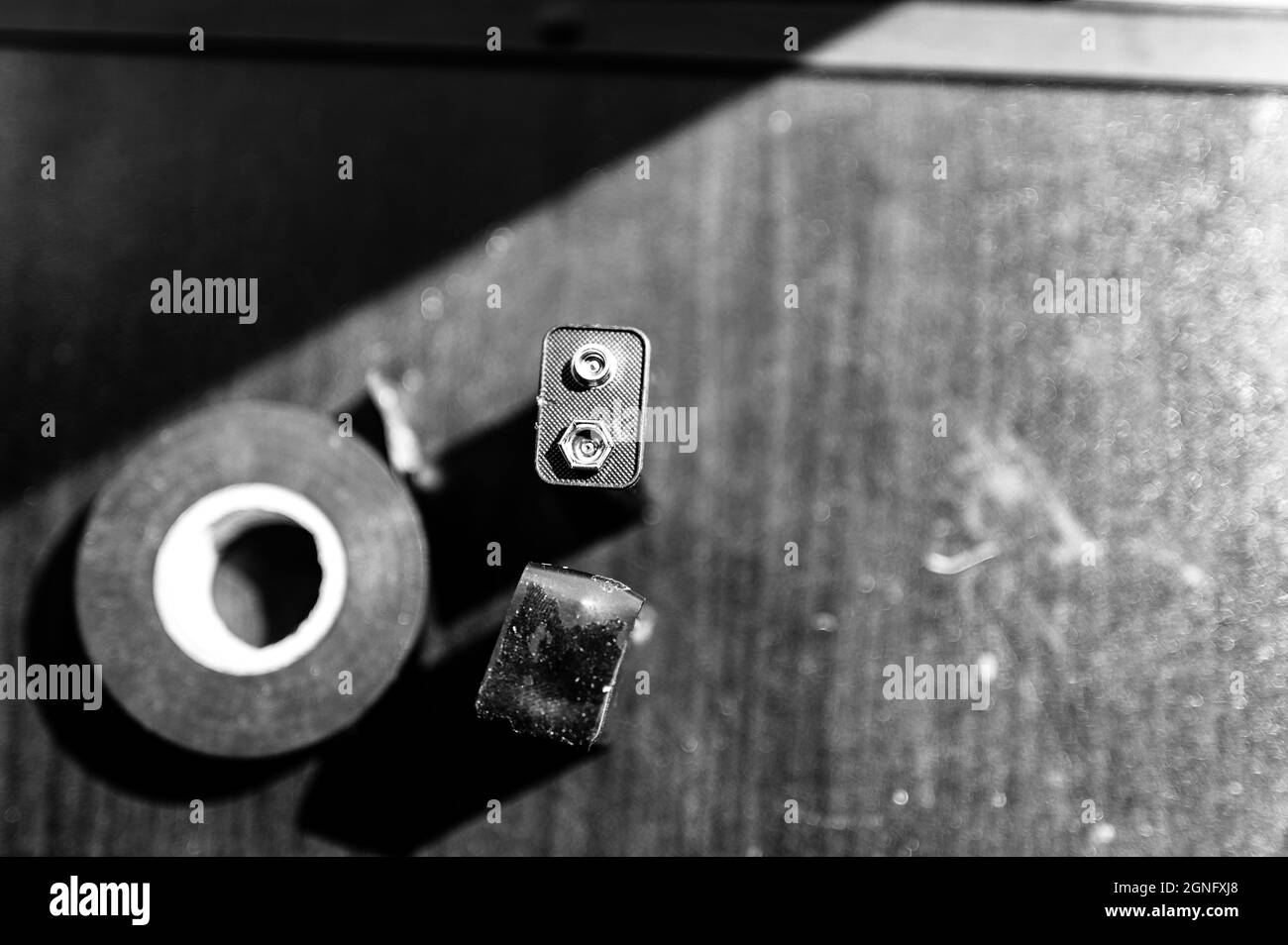 9 volt dead battery with terminals covered with electrical tape for