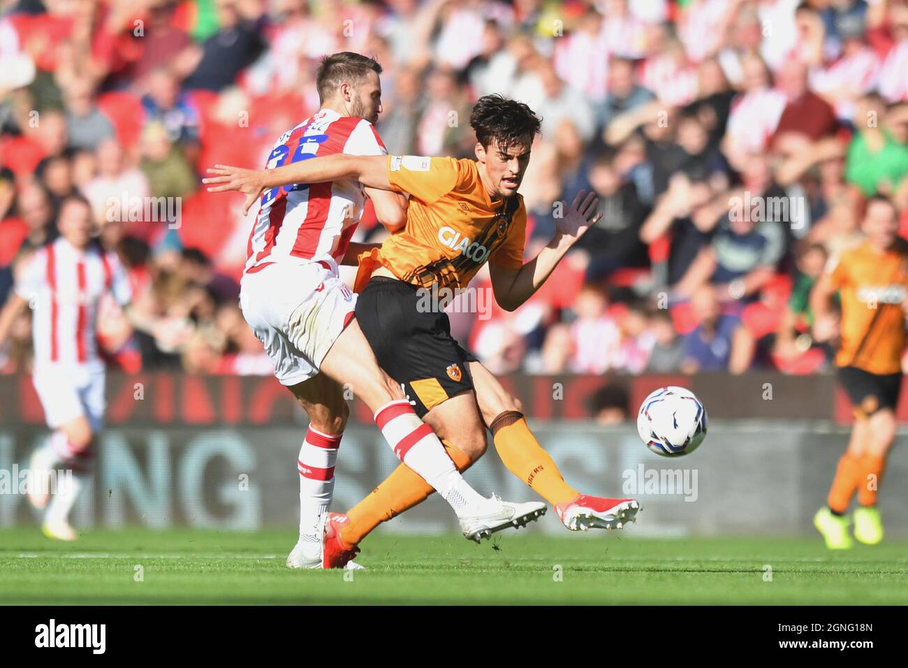Hull City's Jordy de Wijs (right) is tackled by Stoke City's Nick Powell during the Sky Bet Championship match at the bet365 Stadium, Stoke. Picture date: Saturday September 25, 2021. Stock Photo