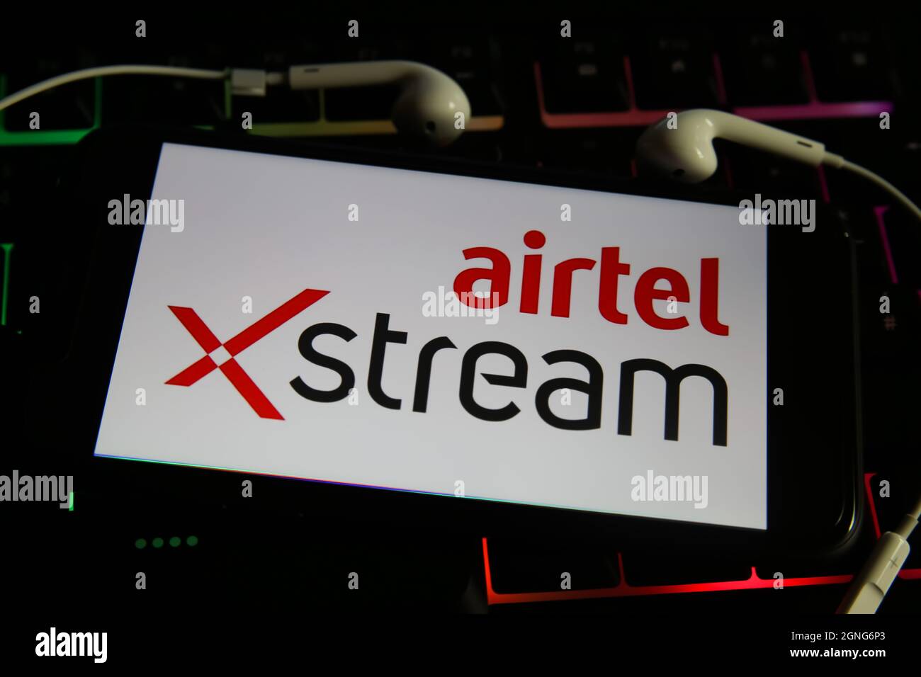 Viersen, Germany - May 9. 2021: View on mobile phone screen with logo lettering of movie streaming service airtel stream on computer keyboard Stock Photo