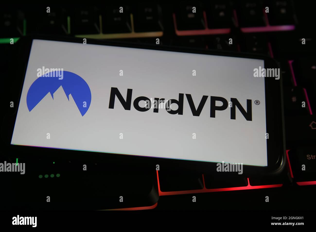 Viersen, Germany - May 9. 2021: View on mobile phone screen with logo lettering of vpn service nordvpn company on computer keyboard (focus on center o Stock Photo