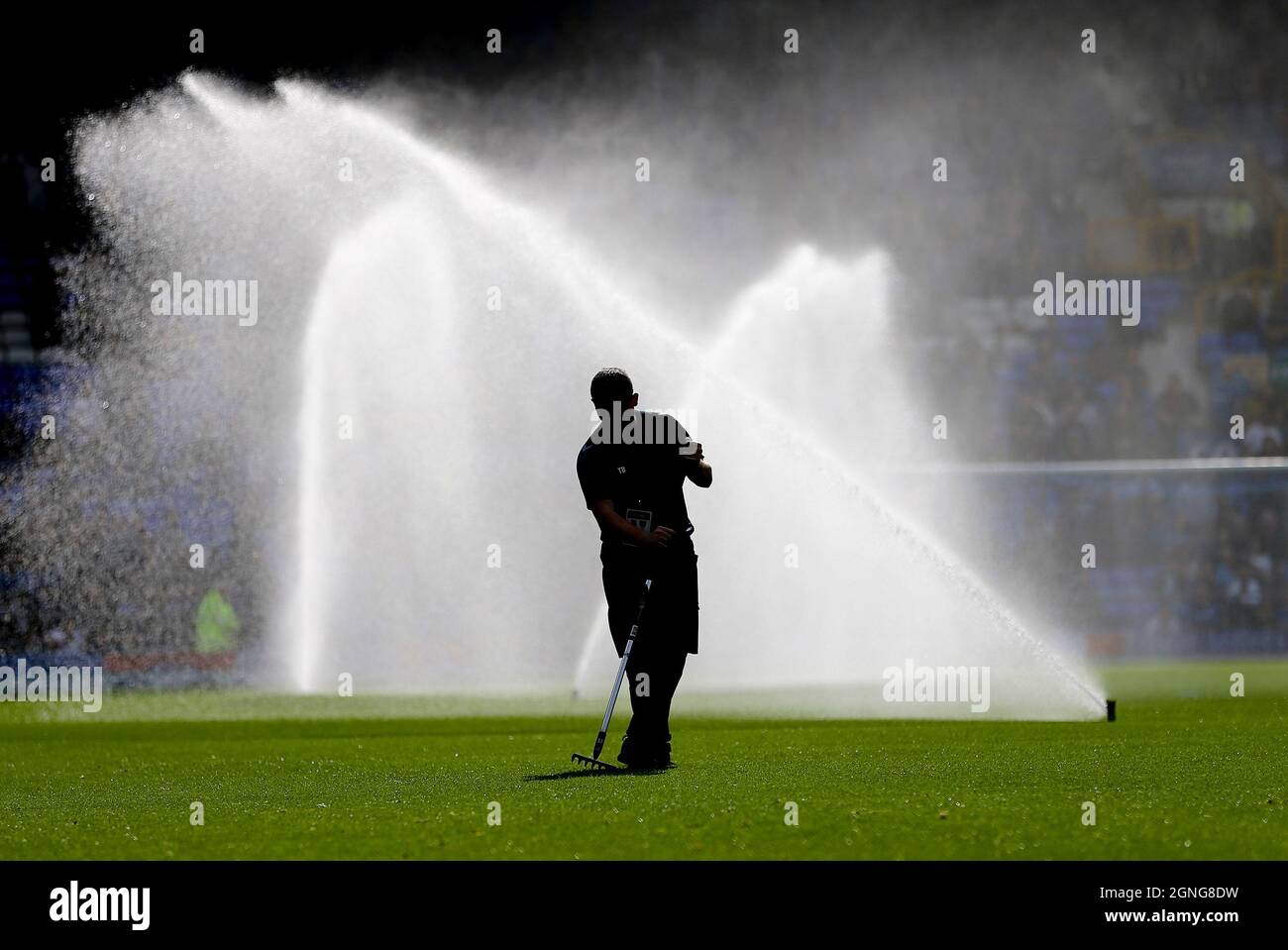 Everton, UK. 25th Sep, 2021. a groundsman works on the grass as the water is turned on behind hin. Premier League match, Everton v Norwich City at Goodison Park in Liverpool on Saturday 25th September 2021. this image may only be used for Editorial purposes. Editorial use only, license required for commercial use. No use in betting, games or a single club/league/player publications. pic by Chris Stading/Andrew Orchard sports photography/Alamy Live news Credit: Andrew Orchard sports photography/Alamy Live News Stock Photo