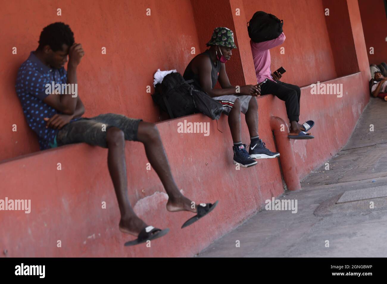 Migrants from Haiti rest outside a shelter after they arrived en masse at the U.S. border and thousands of their compatriots were cleared from a frontier camp, in Monterrey, Mexico September 24, 2021. Picture taken September 24, 2021. REUTERS/Edgard Garrido Stock Photo