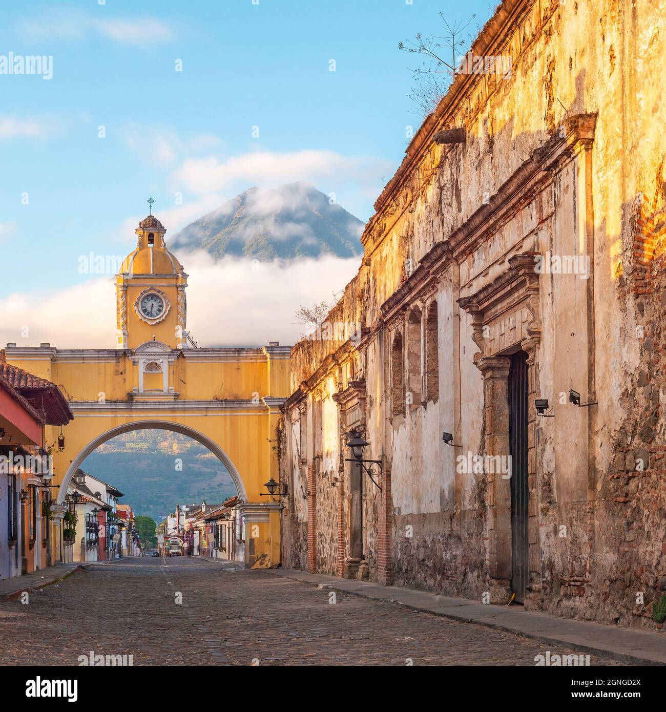 Santa Catalina arch and Agua volcano at sunrise, Antigua city, Guatemala. Stock Photo