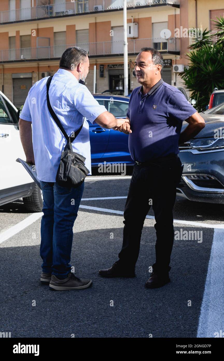 Locri, Italy. 25th Sep, 2021. Domenico Lucano (R) seen talking to his supporter before the trial, The pro-migrant former Mayor of Riace, Domenico “Mimmo” Lucano, arrived at Locri's courthouse for the defensive conclusive statements of the trial for illegal immigration charges. The final session of the trial has been scheduled for September 27, 2021. Lucano is also running for upcoming regional elections with the list “Un'altra Calabria è possibile”. (Photo by Valeria Ferraro/SOPA Images/Sipa USA) Credit: Sipa USA/Alamy Live News Stock Photo