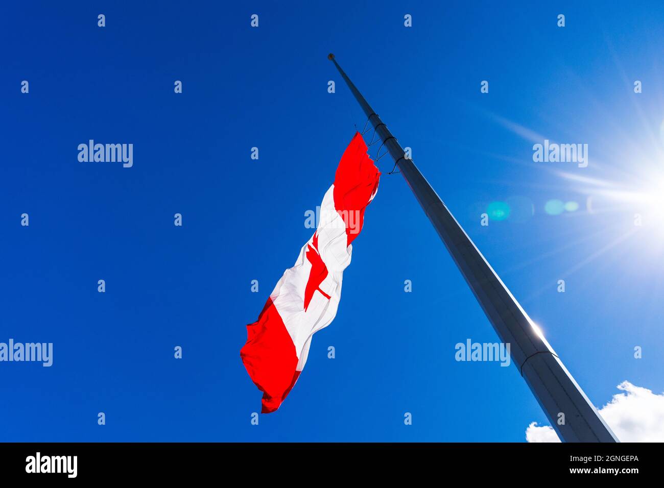 A Canadian flag flies at half staff in honour of indigenous residential