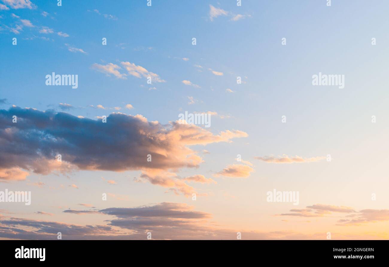 fluffy clouds on a sunset background with dramatic light Stock Photo ...