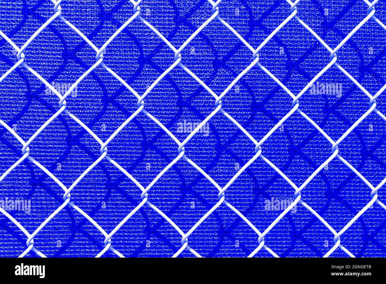 Abstract blue background shows a macro of a chain link fence. Stock Photo