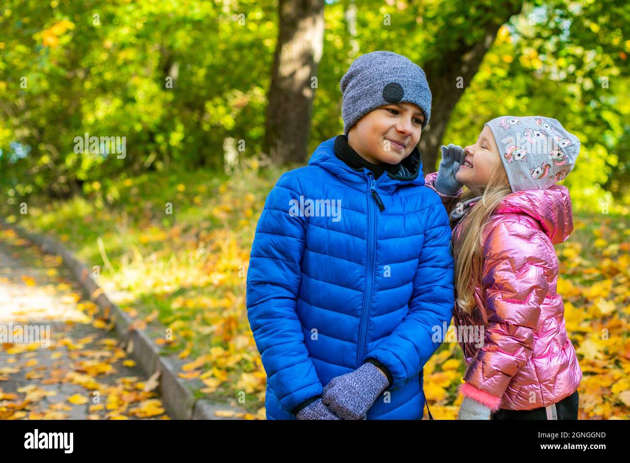 A boy and a girl are talking and smiling Stock Photo