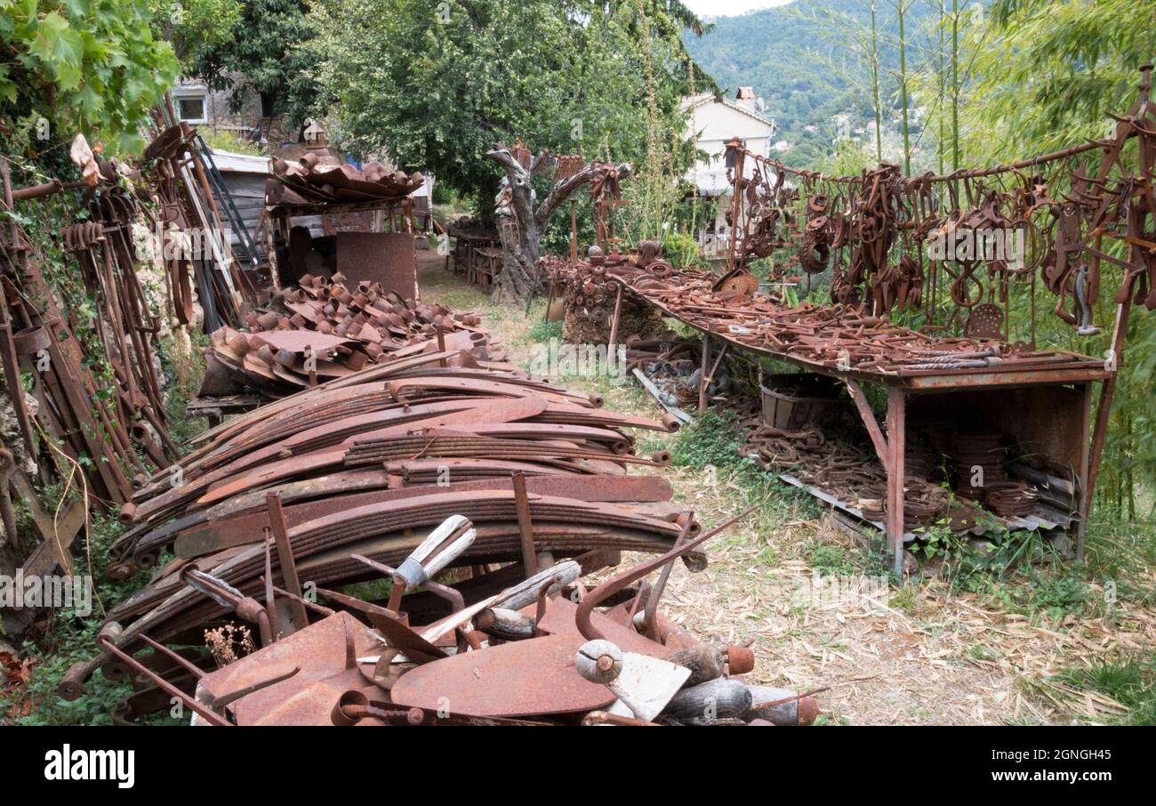 Organized junkyard. Old worn out rusty machine parts and tools used in