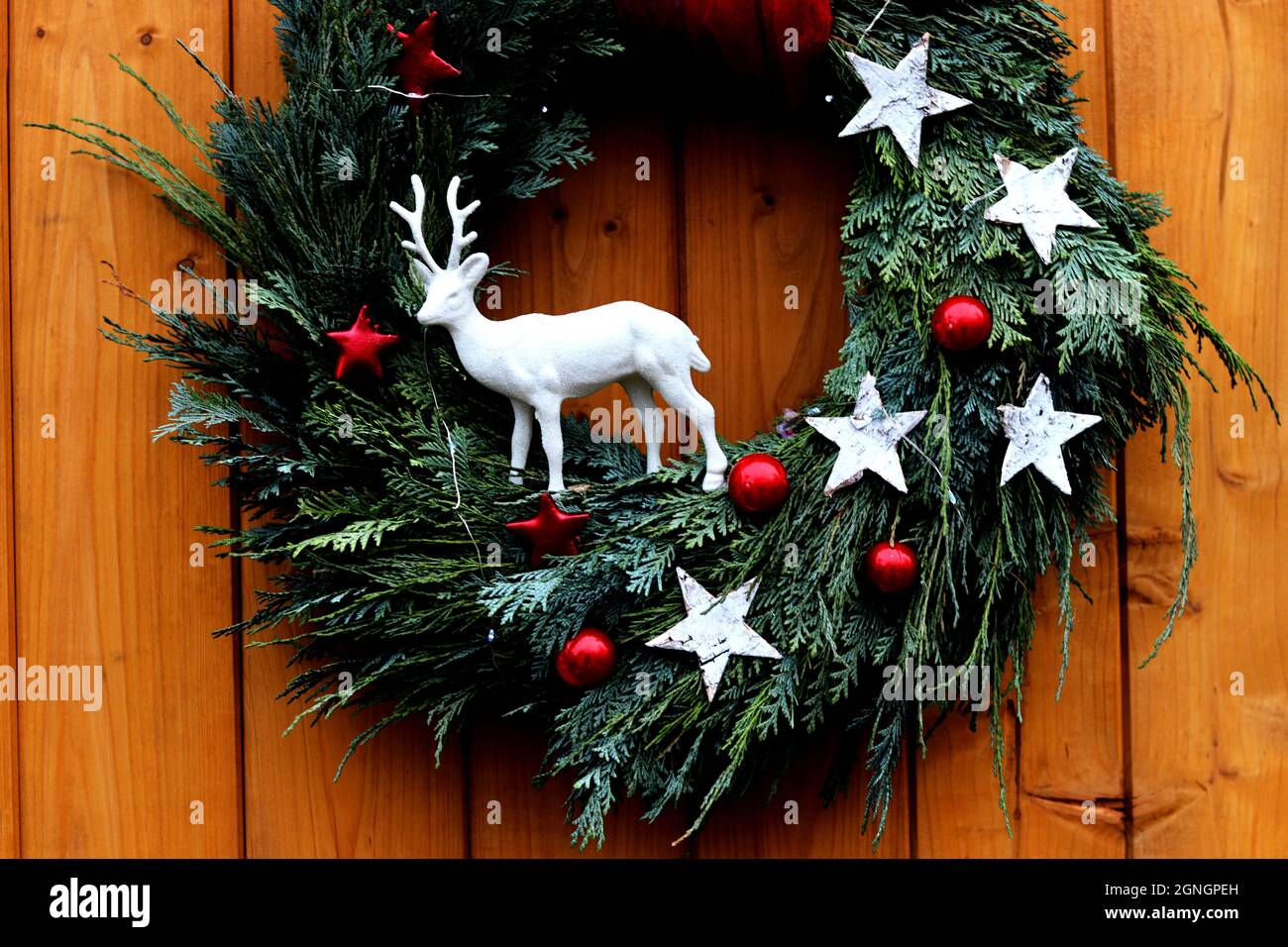 Natural Christmas wreath on a front wooden door - close up Stock Photo