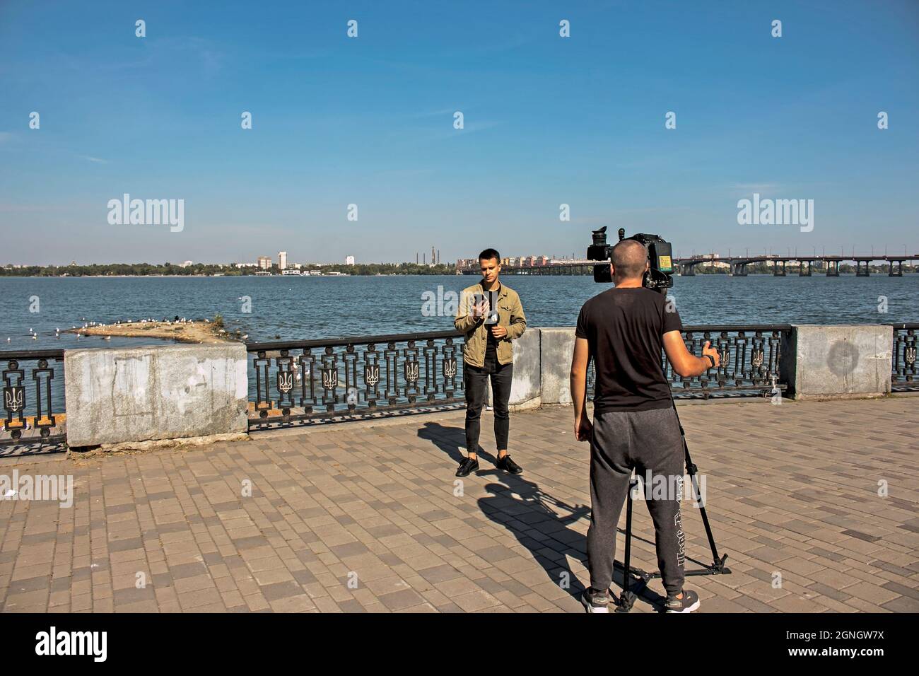 Dnepropetrovsk, Ukraine - 09.17.2021: Local TV journalists are filming an environmental issue. A new island was formed on the Dnieper River. Stock Photo