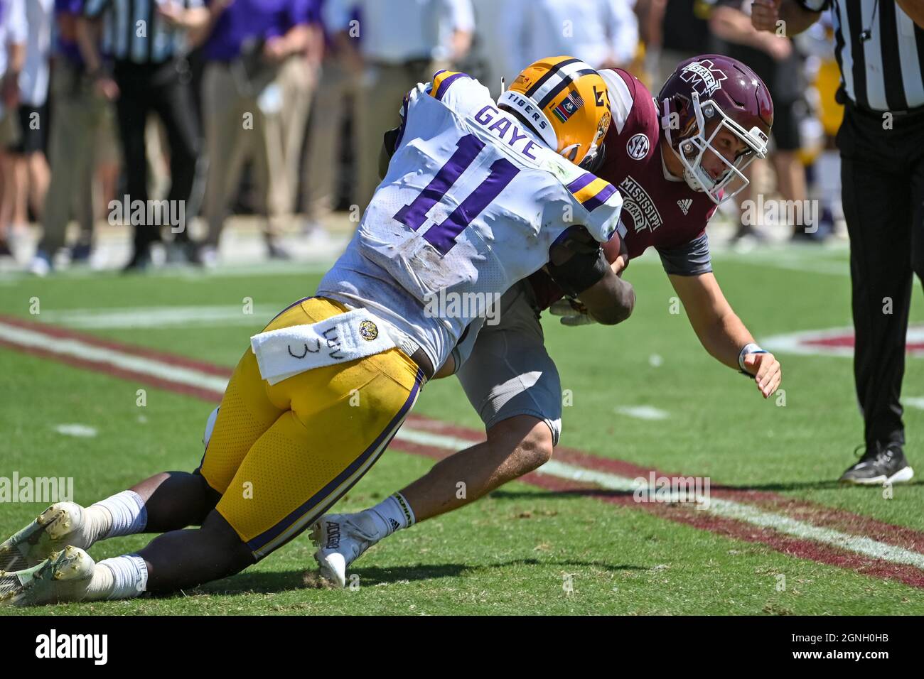 Starkville, MS, USA. 25th Sep, 2021. Mississippi State Bulldogs quarterback Will Rogers (2) is brought down by LSU Tigers defensive end Ali Gaye (11) during the NCAA football game between the LSU Tigers and the Mississippi State Bulldogs at Davis Wade Stadium in Starkville, MS. Kevin Langley/CSM/Alamy Live News Stock Photo
