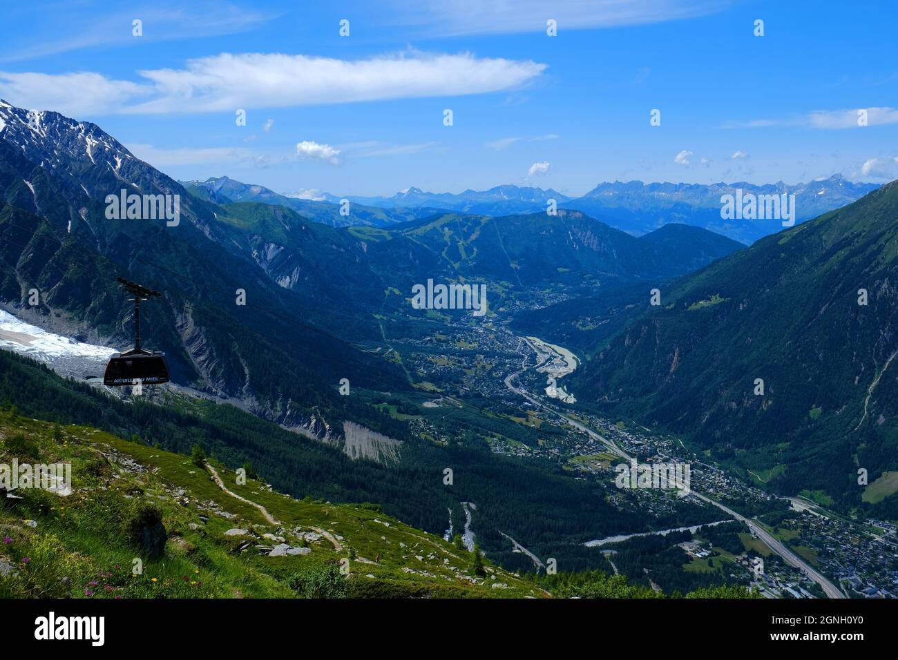 Amazing landscape with Chamonix Valley and cable car coach going to the Aiguille du Midi mountain in the Mont Blanc massif , Chamonix, France Stock Photo