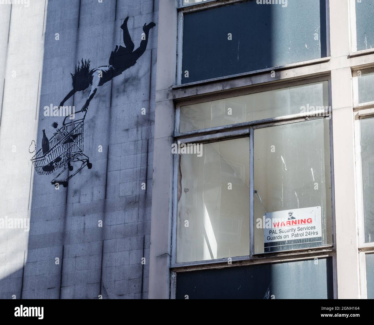 Banksy’s ‘Shop Till You Drop’ in London’s Mayfair, London highlighting the perils of consumerism. Painted in November 2011 Stock Photo