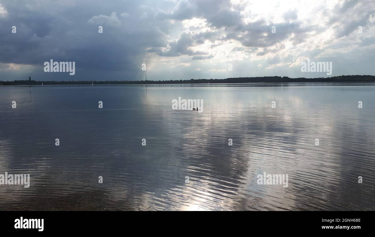 Stunning view of white cloudy sky reflected on the water Stock Photo ...