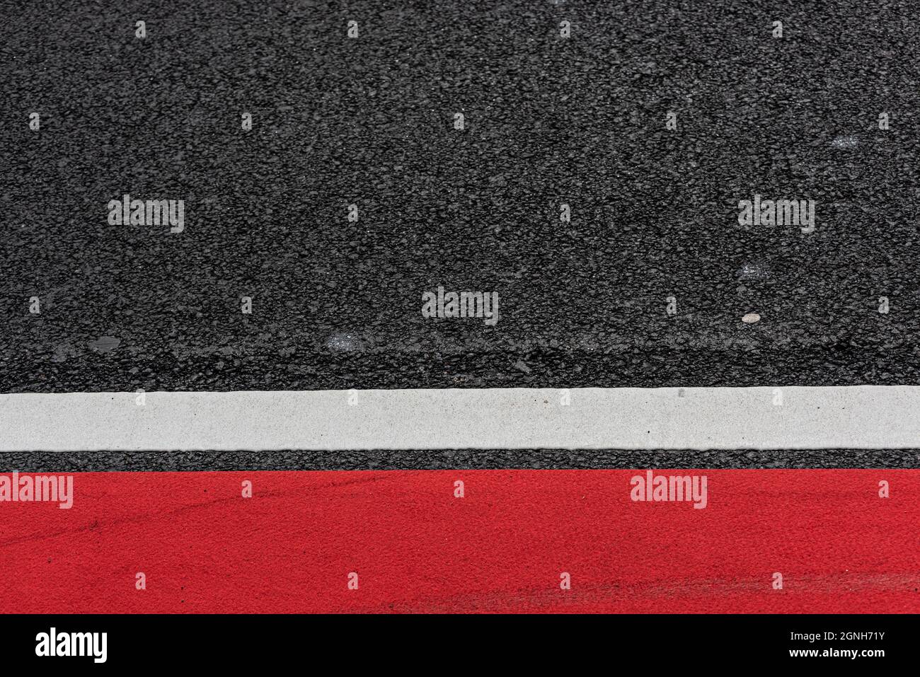 Asphalt decorated with a white line and a red field Stock Photo