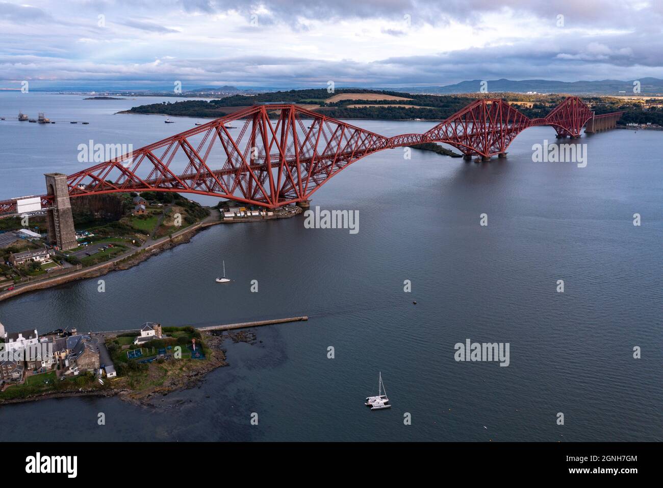 South Queensferry, Eaglesham, Scotland, UK. 25th Sep, 2021. PICTURED: Forth Rail Bridge, which is a national monument in its own right seen wearing its famous red lead paint which is needed to protect the structure from rusting from the elements. The bridge is painted by a team of painters, and when they finish they then start all over again. The bridge transports ScotRail train services from the east coast railway into Edinburgh's main hub of Waverley Train Station. Credit: Colin Fisher/Alamy Live News Stock Photo