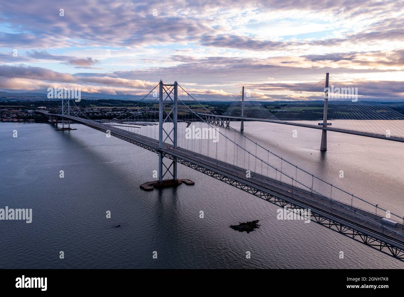 South Queensferry, Eaglesham, Scotland, UK. 25th Sep, 2021. PICTURED: Aerial drone view of Forth bridges. Forth Road Bridge seen with no traffic on it. Since a crack was discovered in part of the bridges structure and subsequently repaired, the bridge had seen light traffic, with the new Queensferry Crossing being built, which now takes the majority of vehicles, the Forth Road Bridge still takes busses and taxis. Credit: Colin Fisher/Alamy Live News Stock Photo