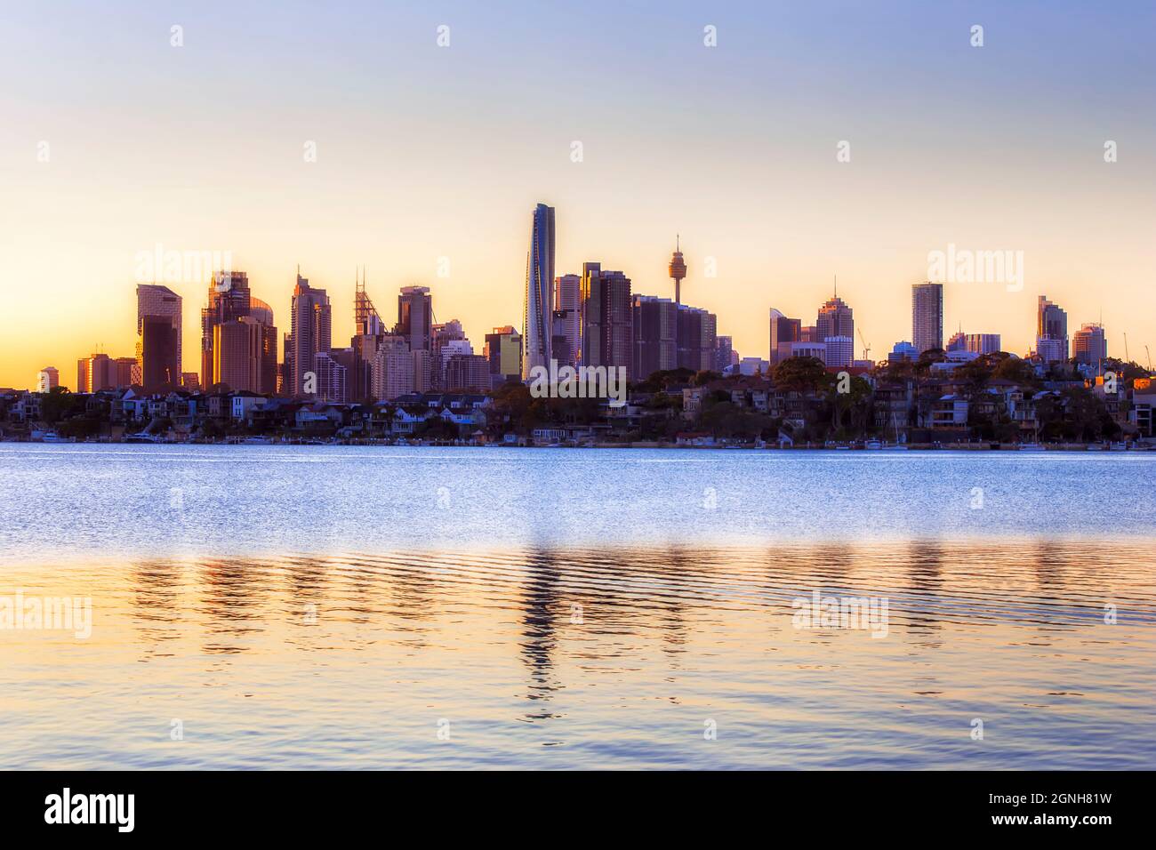 Skyline of City of Sydney over Inner West waterfront with reflection in ...