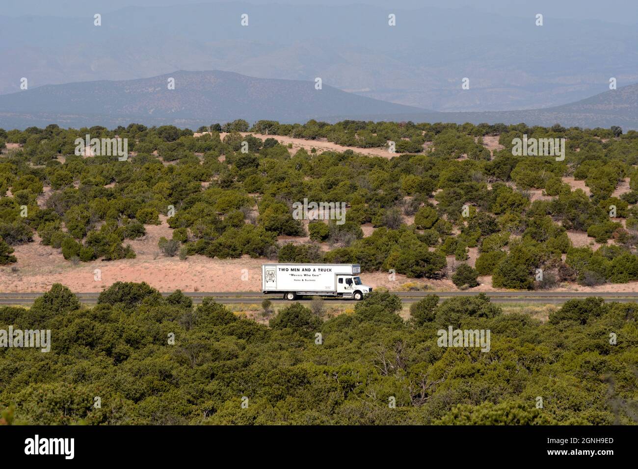 A moving van travels along a rural highway in New Mexico. Stock Photo