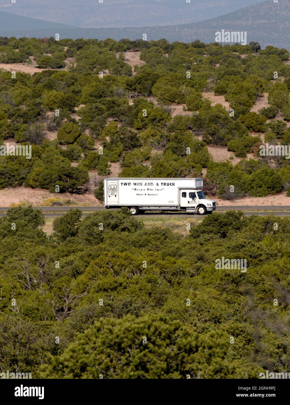 A moving van travels along a rural highway in New Mexico. Stock Photo