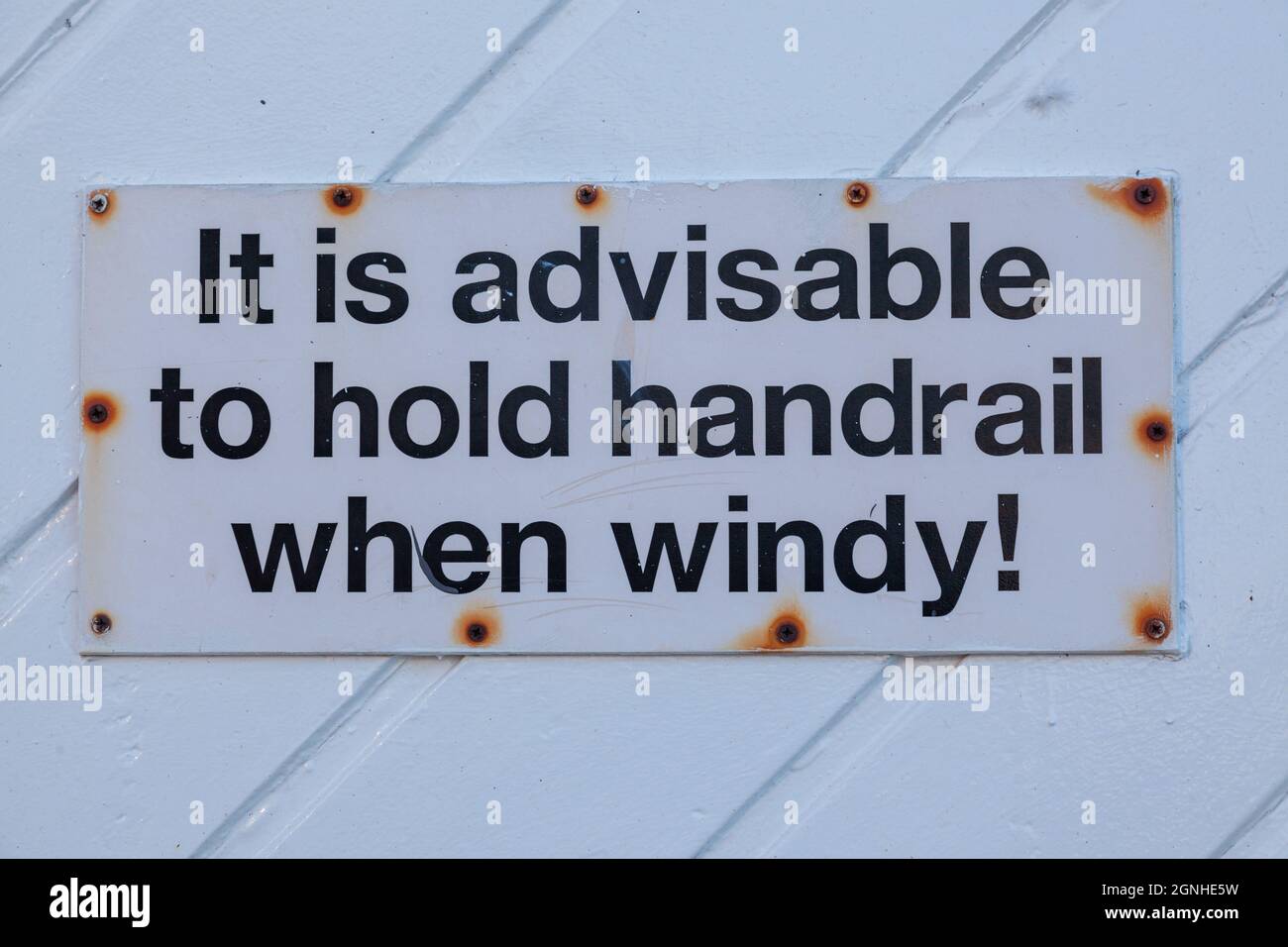 warning to hold a handrail in wind Stock Photo