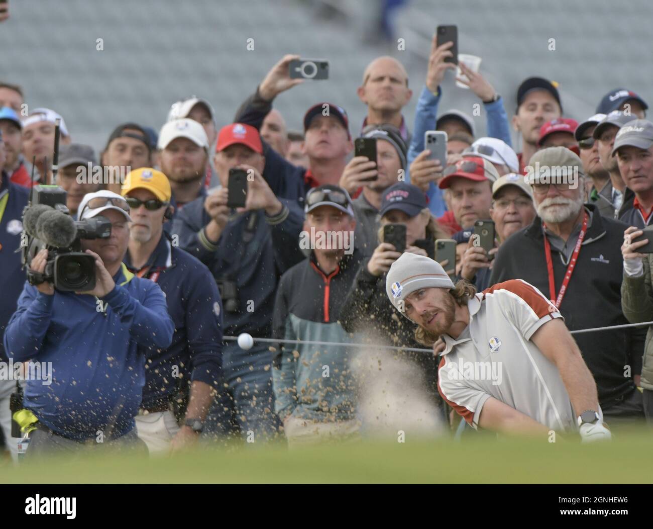 Kohler, United States. 25th Sep, 2021. Team Europe's Tommy Fleetwood attempts to chip the ball out of the sand but to make it on the green in his first attempt, to the delight of the Team USA fans behind him in the 43rd Ryder Cup at Whistling Straits on Saturday, September 25, 2021 in Kohler, Wisconsin. Photo by Mark Black/UPI Credit: UPI/Alamy Live News Stock Photo