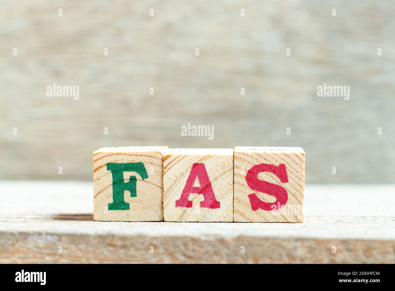 Alphabet letter block in word FAS (Abbreviation of Fetal alcohol syndrome, Free alongside or Financial accounting standards) on wood background Stock Photo