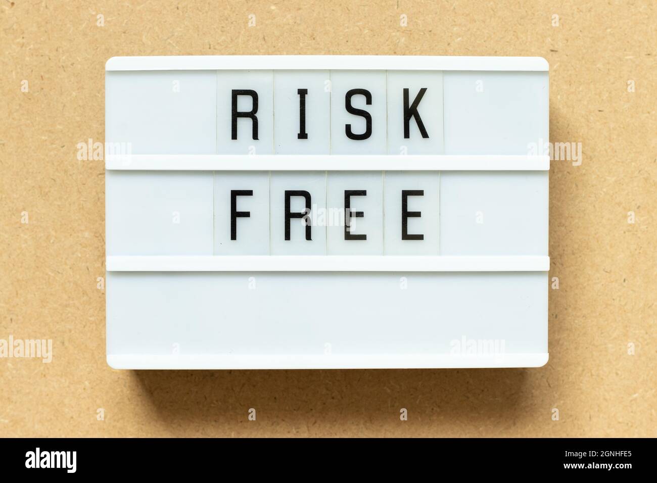 Lightbox with word risk free on wood background Stock Photo
