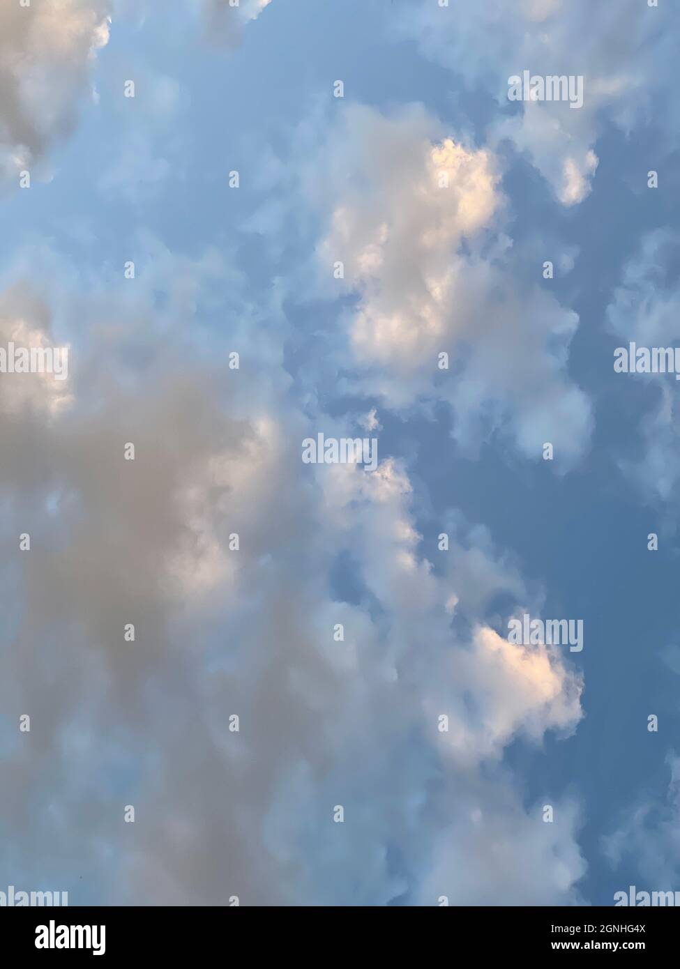 Beautiful sky with clouds illuminated by setting sun Stock Photo
