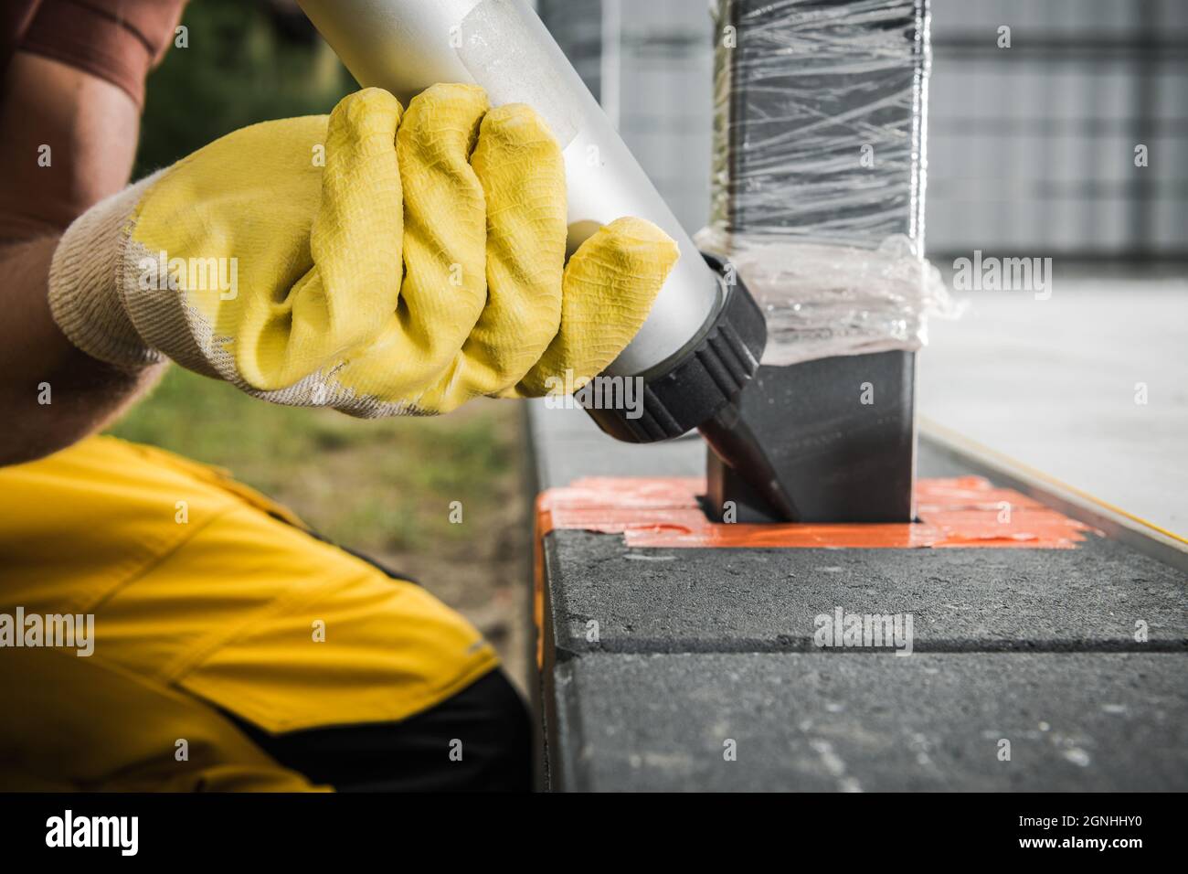Bricks Paving Worker Injection Silicone Material Between Fence Pole and Concrete Bricks