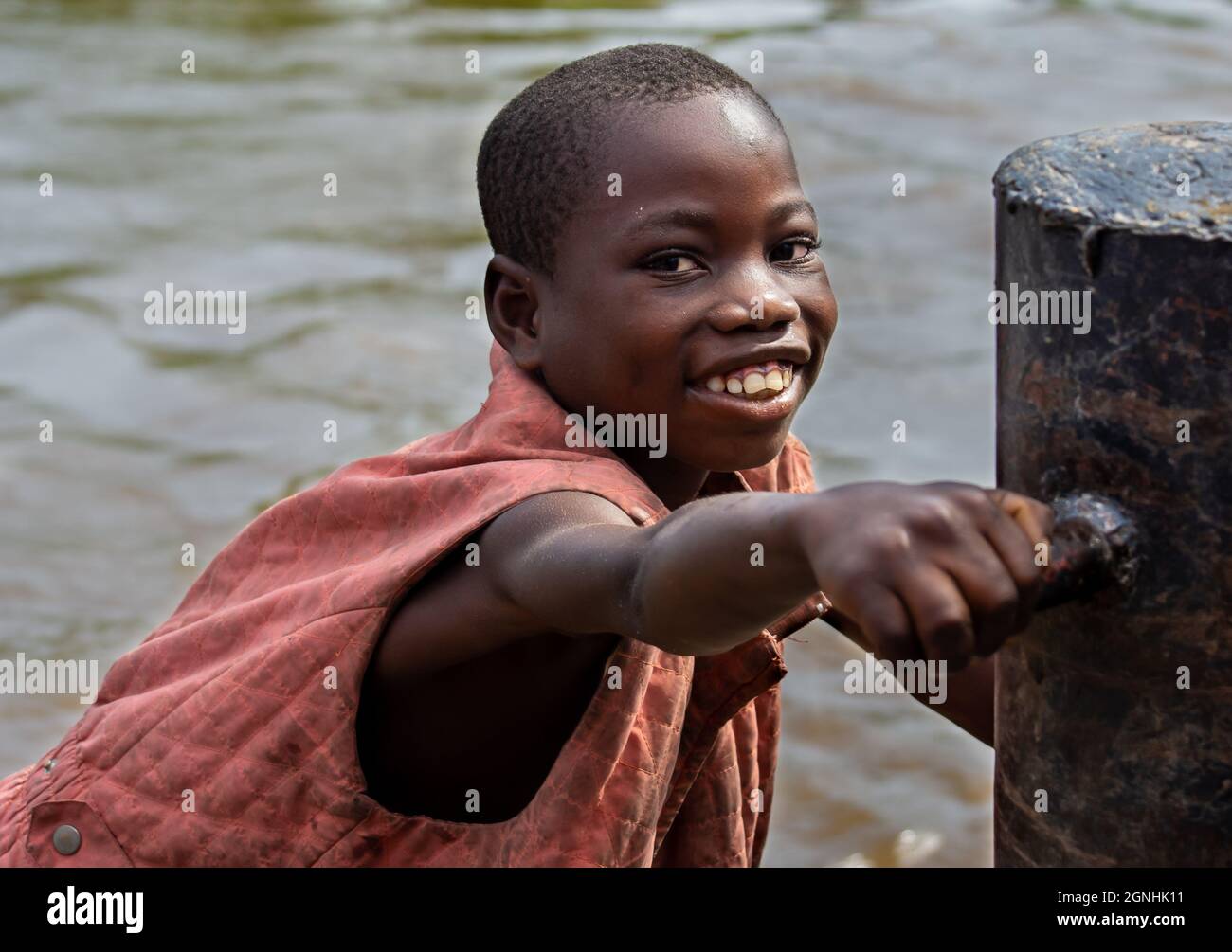 Young boy making a living off the Congo River. Mbandaka, Democratic Republic of Congo Stock Photo