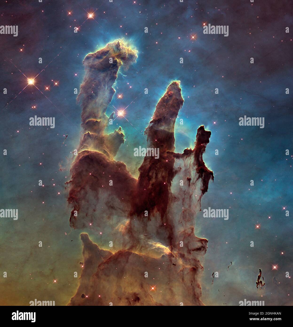 The famous Pillars of Creation,a part of a small region of the Eagle Nebula, a vast star-forming region 6,500 light-years from Earth.The colors in the image highlight emission from several chemical elements. Oxygen emission is blue, sulfur is orange, and hydrogen and nitrogen are green. . Image source NASA/ESA Hubble Space Telescope Stock Photo
