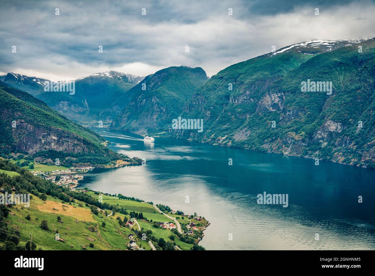 From the bird's-eye view of Sognefjorden fjord. Great summer scene with Aurlandsvangen village, Norway. Traveling concept background. Stock Photo