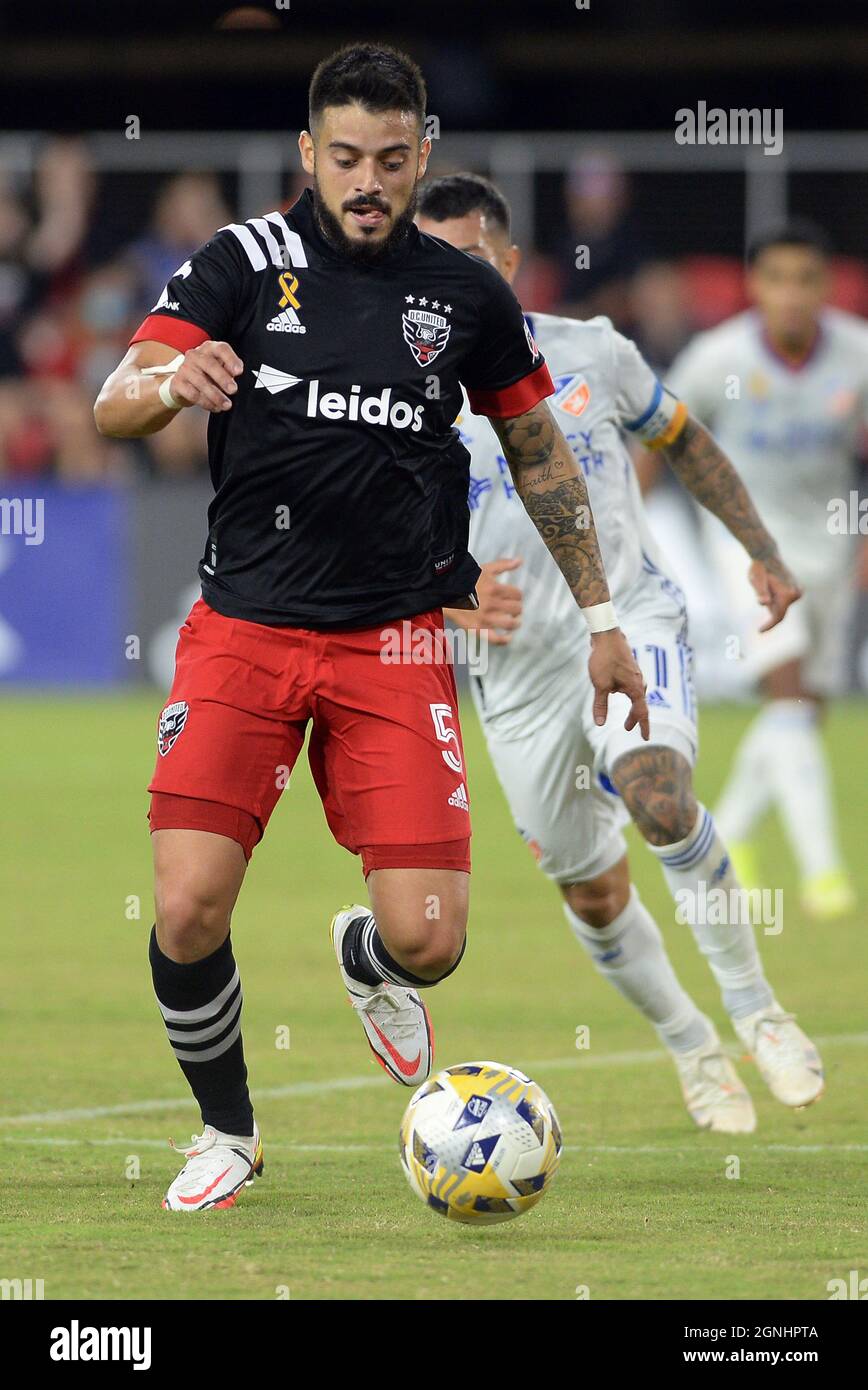 Washington, USA. 25th Sep, 2021. D.C. United midfielder Junior Moreno (5)  works the ball forward ahead of FC Cincinnati midfielder Luciano Acosta  (11) in the first half at Audi Field in Washington,