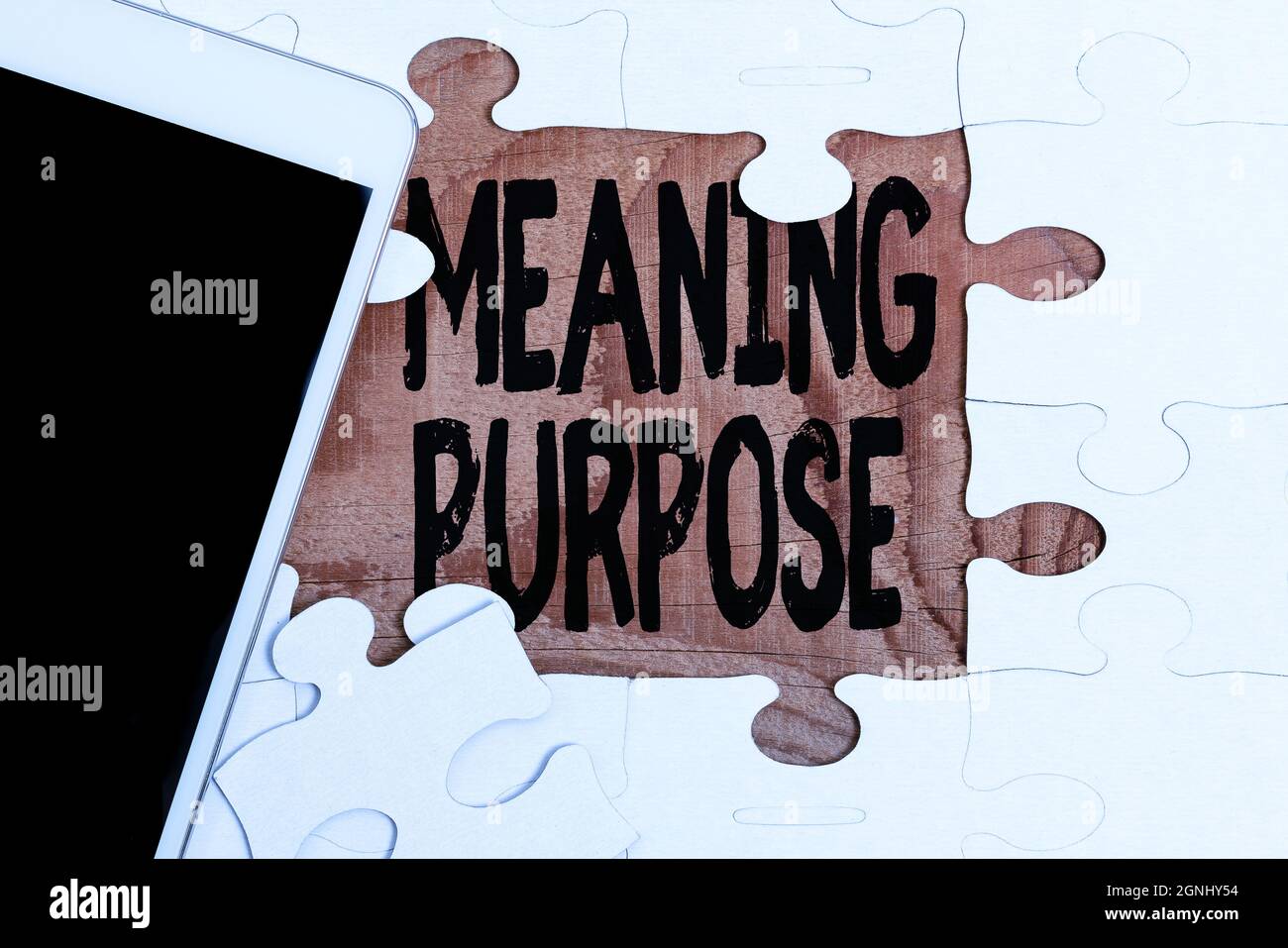 Sign displaying Meaning Purpose. Business approach The reason for which something is done or created and exists Building An Unfinished White Jigsaw Stock Photo