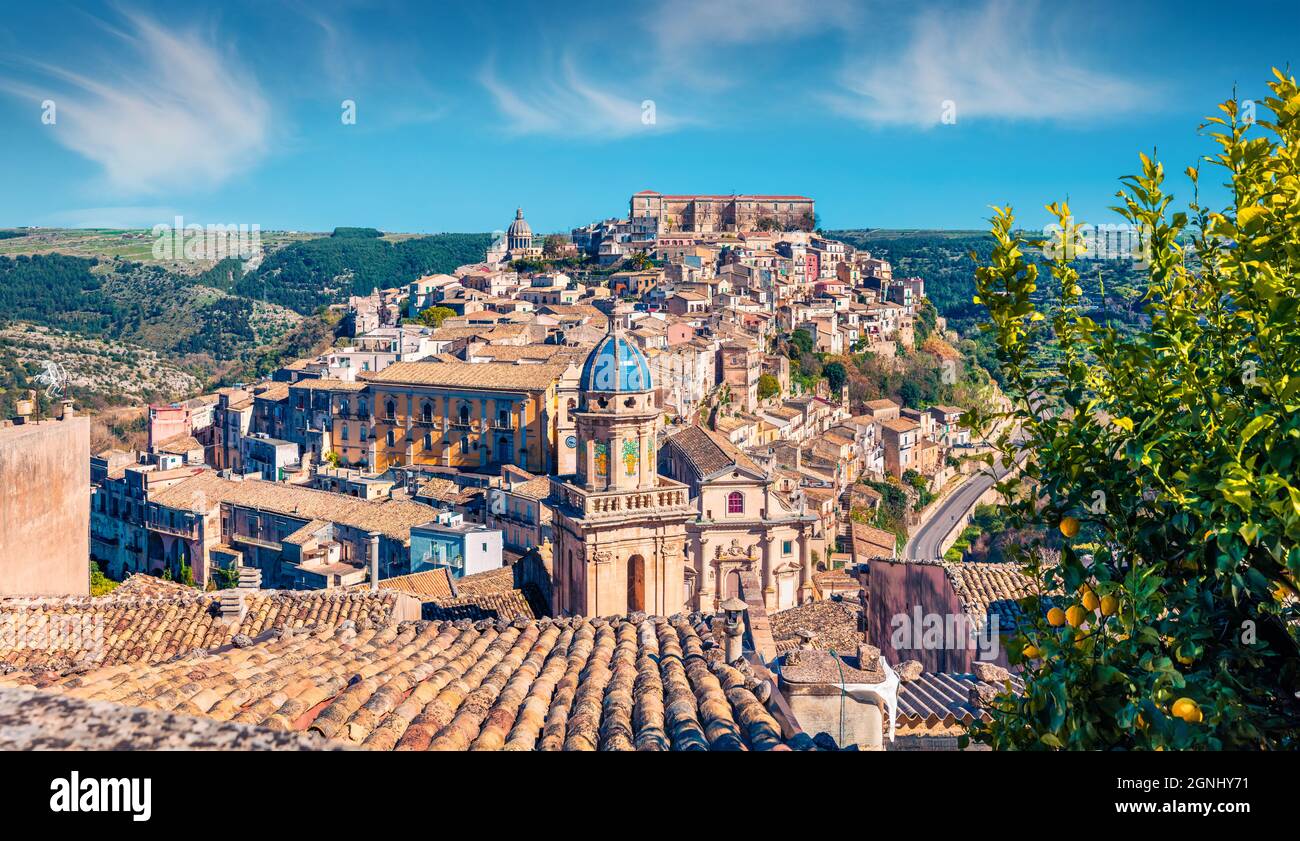 Sunny spring cityscape of Ragusa town with Palazzo Cosentini and Duomo di San Giorgio church on background. Nice afternoon scene of Sicily, Italy, Eur Stock Photo